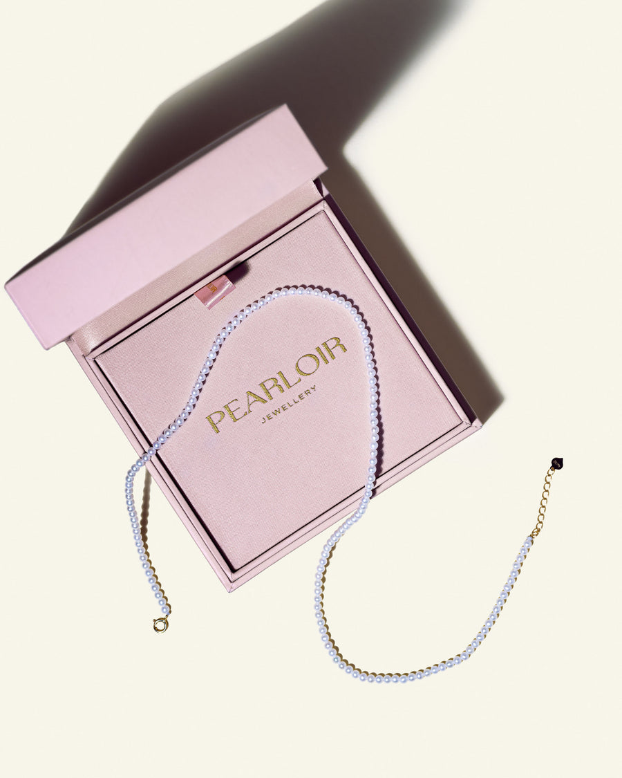 A freshwater Akoya pearl choker is in a gift box with Pearloir sign