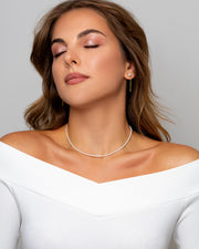 A necklace of alluring freshwater Akoya pearls sits on woman’s neckline