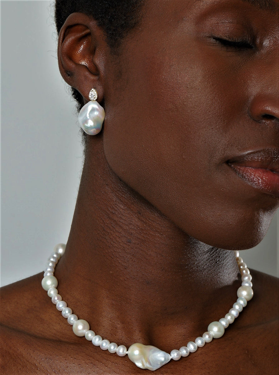 Giselle earrings made of high-quality sterling silver with a white baroque pearl at the bottom and a sparkling pear cut CZ at the top