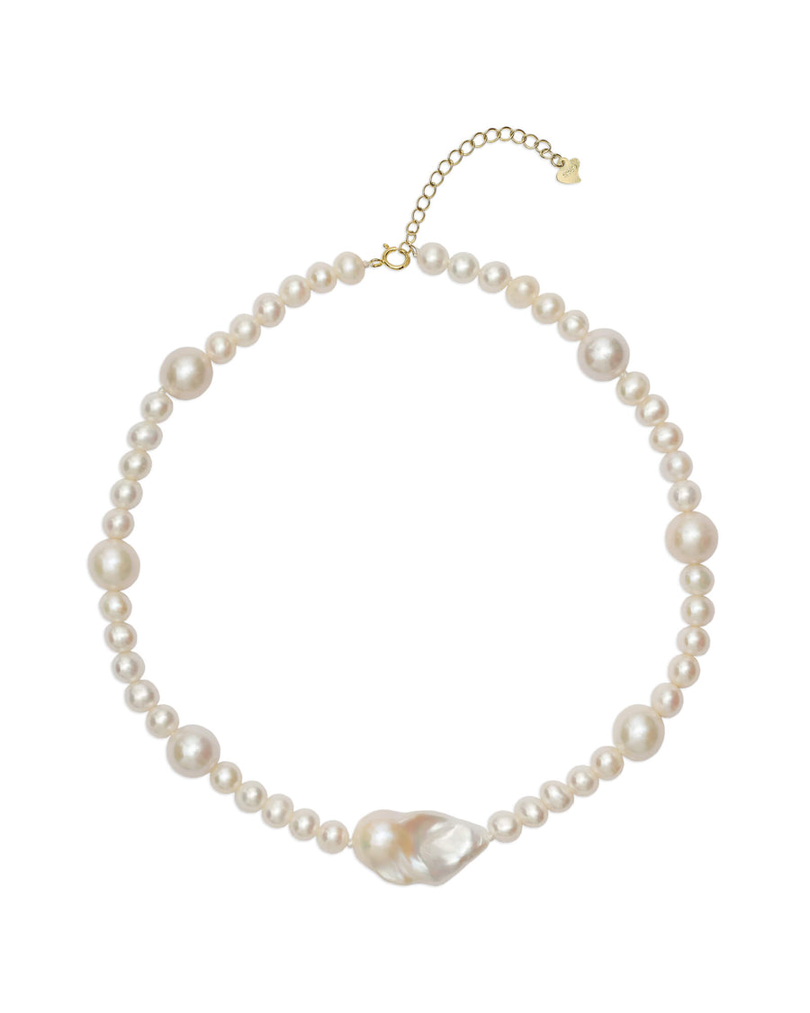 Close-up view of a stunning pearl necklace with a baroque pearl centerpiece and smaller freshwater pearls in varying sizes.